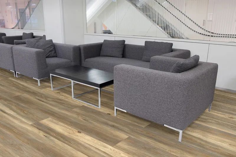 Gray Sofas and a Black Coffee Table in a Modern Waiting Area With Wood-look Flooring — North Coast Tiles in Grafton, NSW