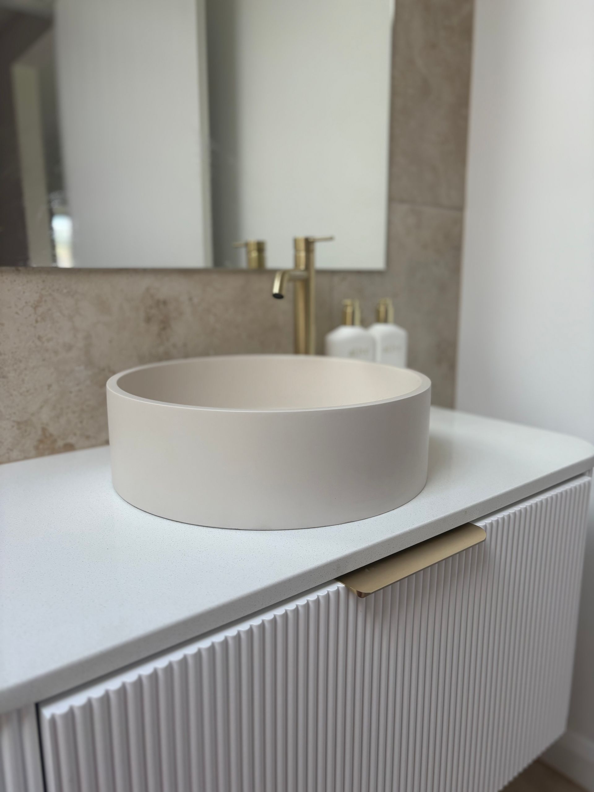 Shower With Gray Tiled Walls and Floor, a Glass Partition, and a Rain Shower Head. a Built-in Shelf Holds Toiletries — North Coast Tiles in Grafton, NSW