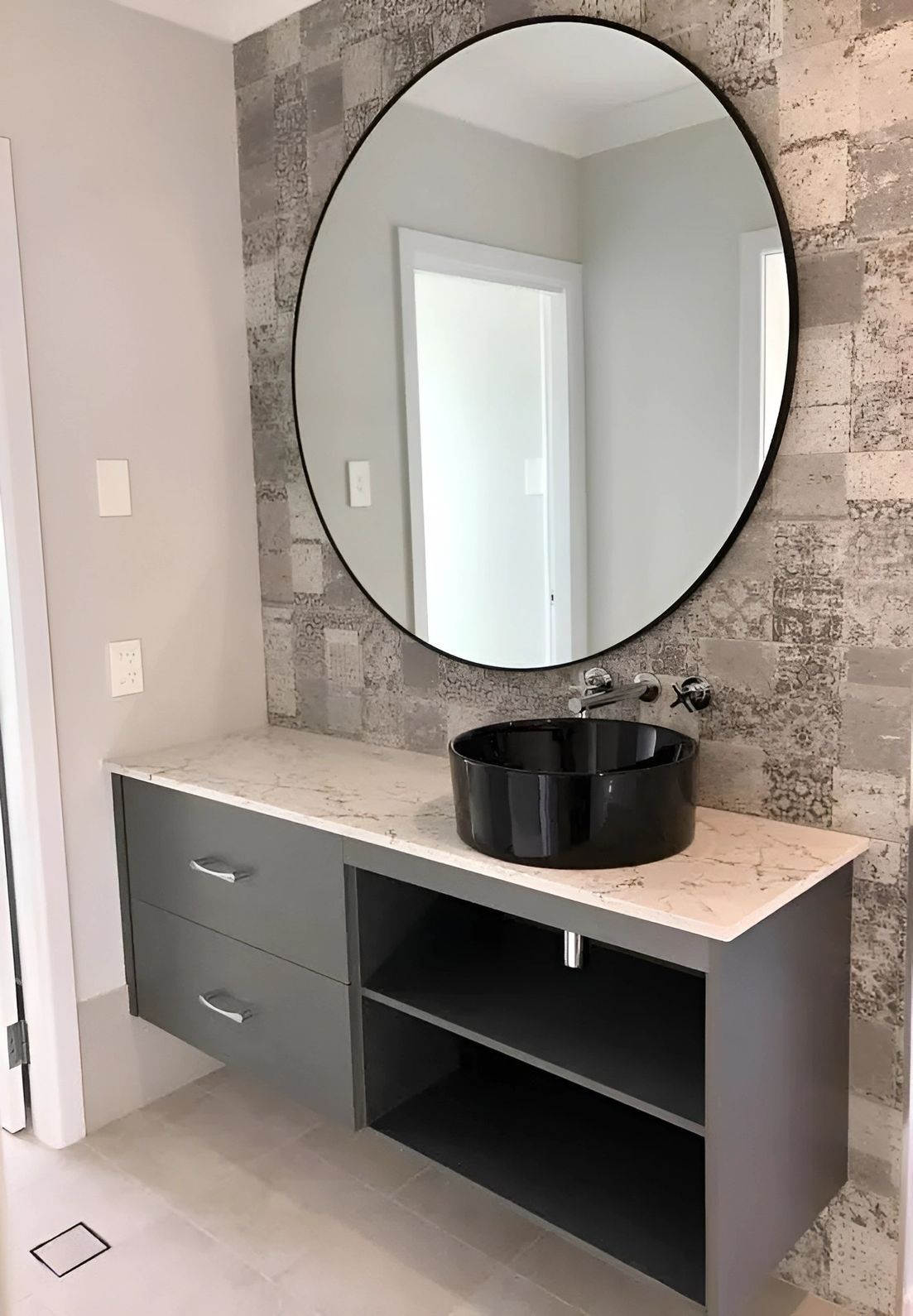 Modern Bathroom With a Gray Vanity, Black Basin, and a Large Round Mirror on a Tiled Wall — North Coast Tiles in Grafton, NSW