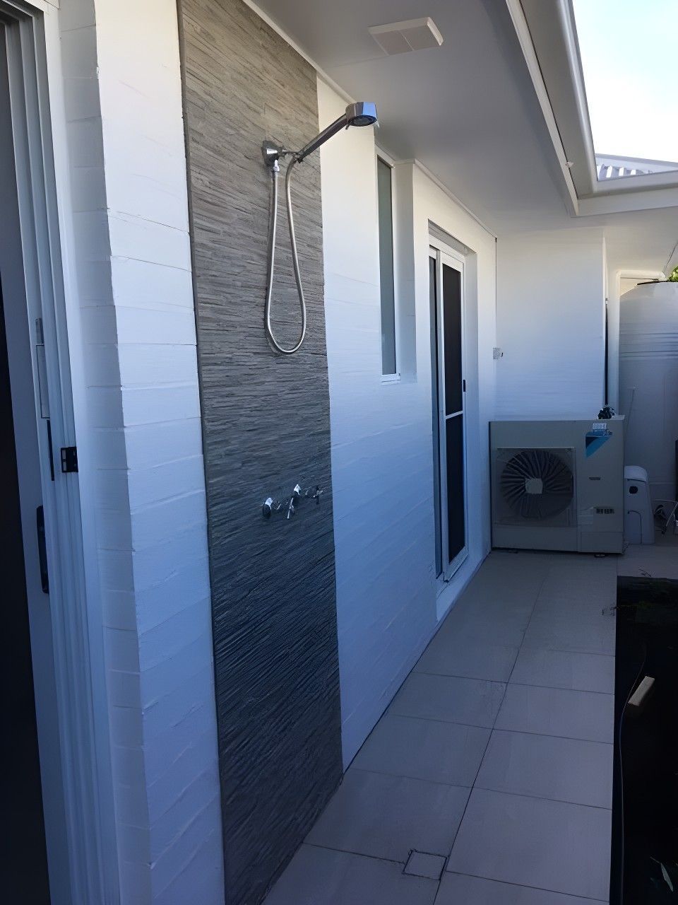 Outdoor Shower With Gray Tile Accent, Beside White Walls, and a Sliding Glass Door — North Coast Tiles in Grafton, NSW