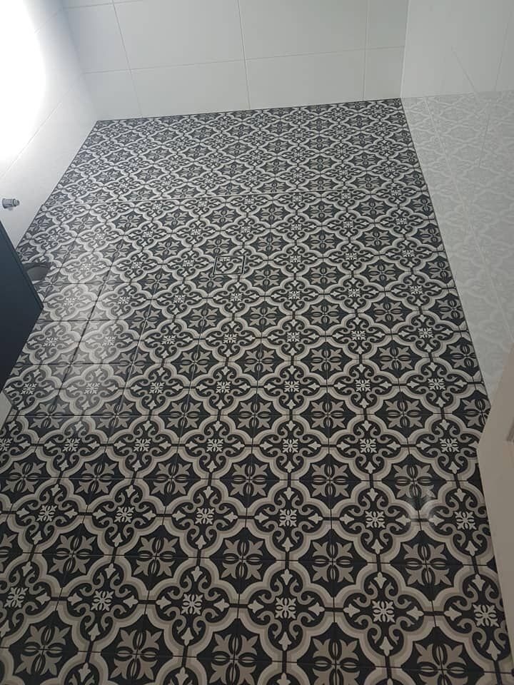 Black and White Patterned Tiles Cover a Floor and Part of a Wall, With a Light-coloured Wall on the Right Side — North Coast Tiles in Maclean, NSW