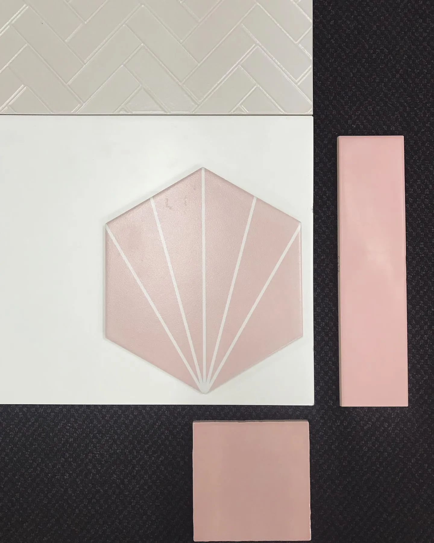 Tile Samples in Shades of White and Pink Arranged on a Dark Surface — North Coast Tiles in Maclean, NSW