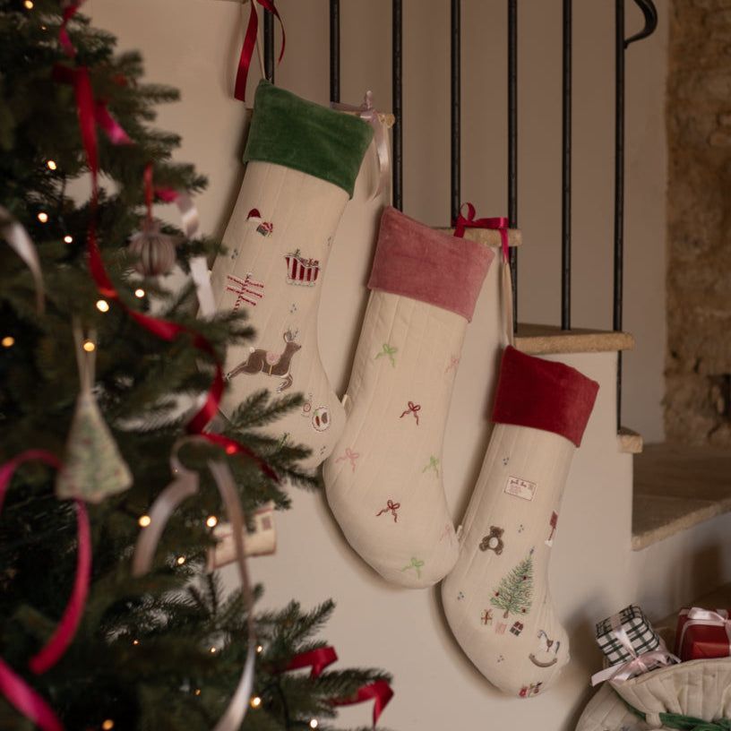 Traditional Christmas Stockings hanging on the stairs waiting for Santa