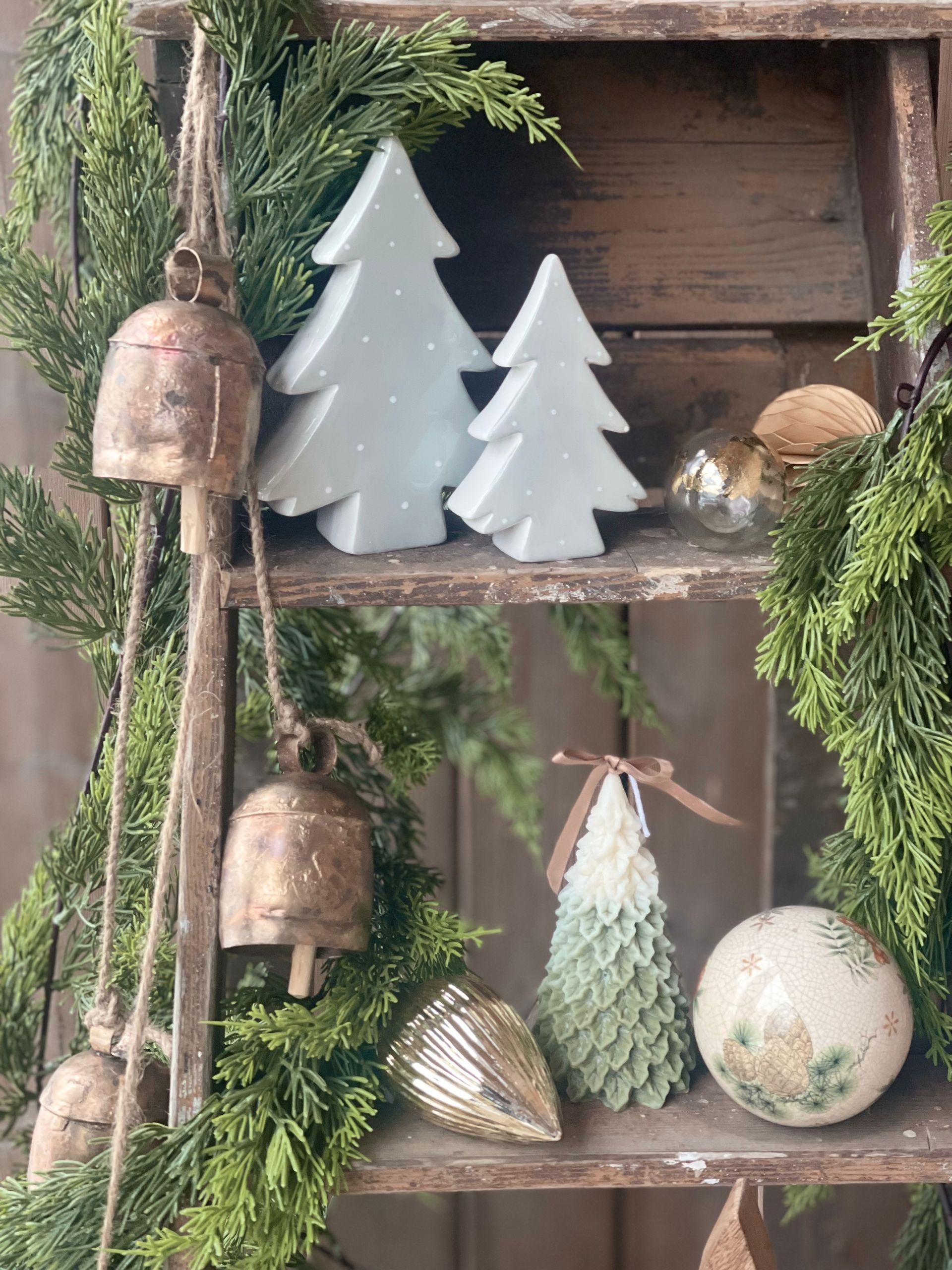 Collection of Christmas accents that exude tradition from ceramic trees to festive candles and charming vintage bell garlands
