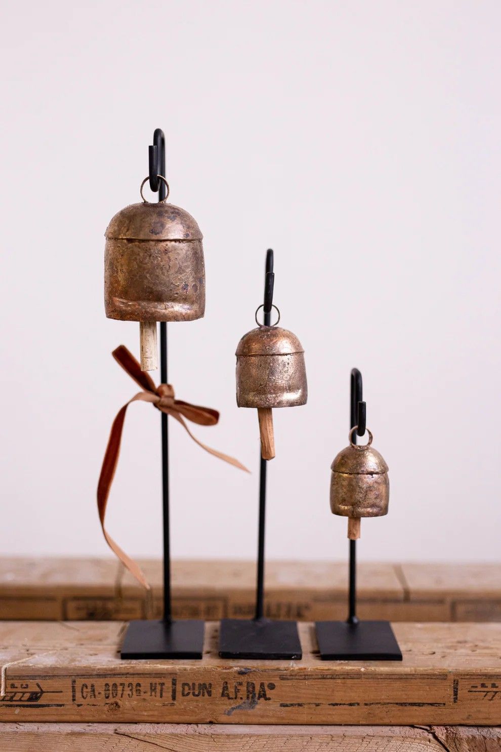 Trio of vintage copper bells on black iron metal stands. A beautiful accent for any season
