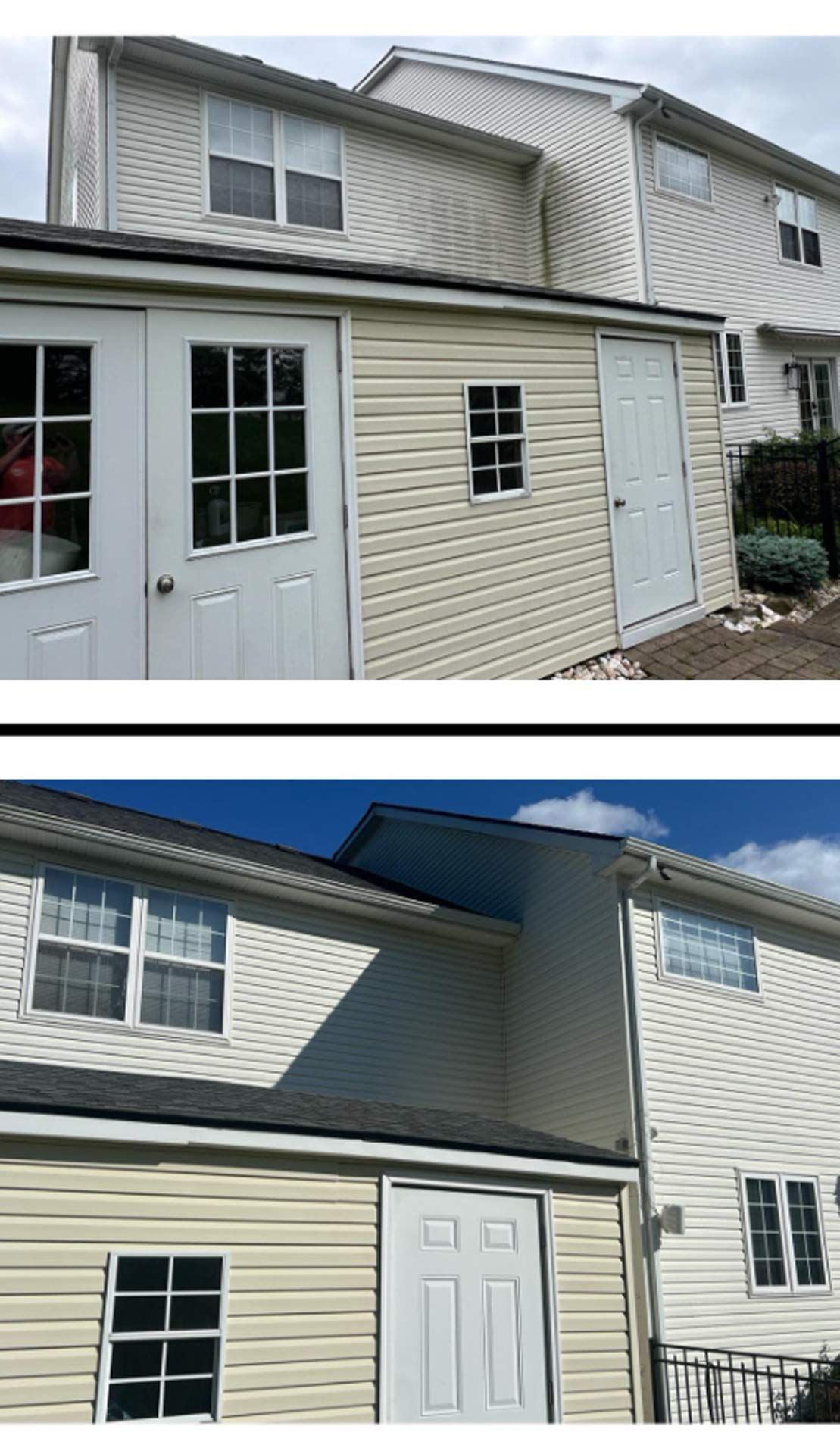 Two-story building with a shed-like structure. White siding, windows, and a white door are visible.