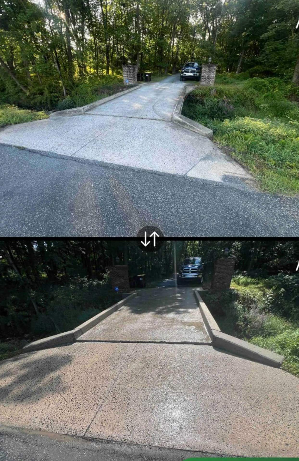 Top-down view of a paved driveway with a car at the end, leading to an entrance framed by brick pillars.