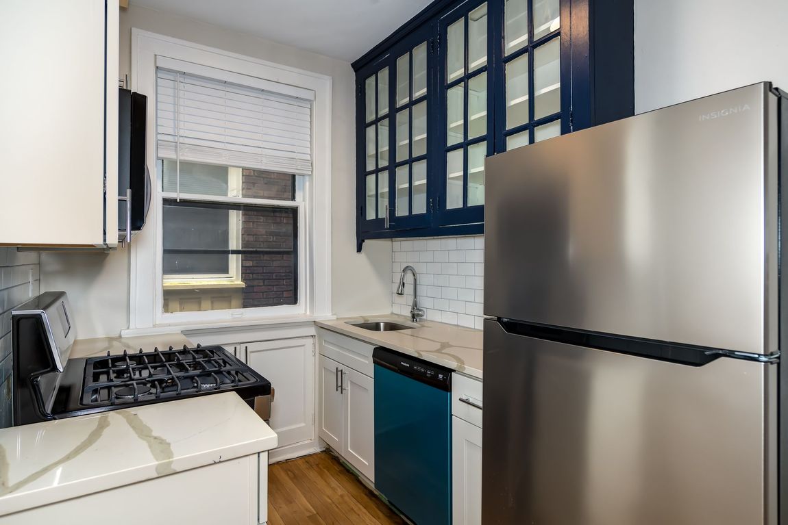 A kitchen with a stainless steel refrigerator , stove , sink and dishwasher.