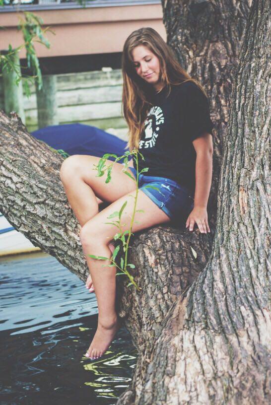 woman sitting on the tree