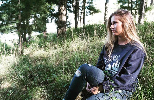 woman sitting in the grass