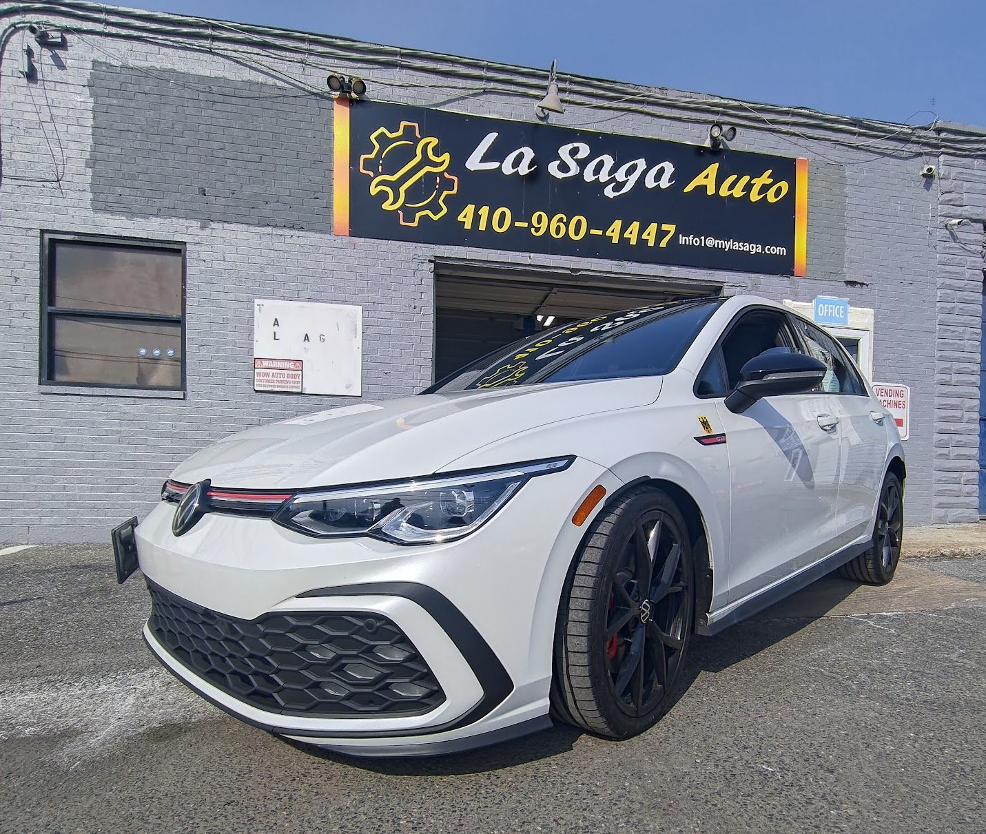 White Car Parked in Front of La Saga Auto Garage | La Saga Auto