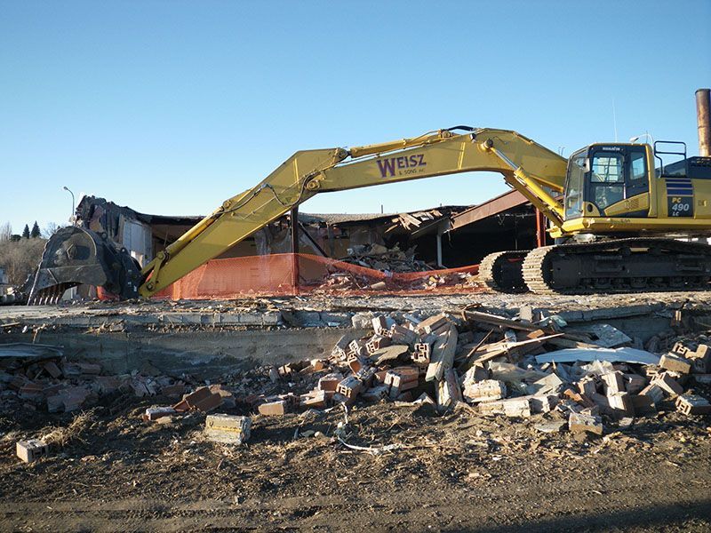 construction crew cleaning up demo site