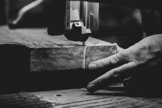 Custom woodworking showing man cutting slab