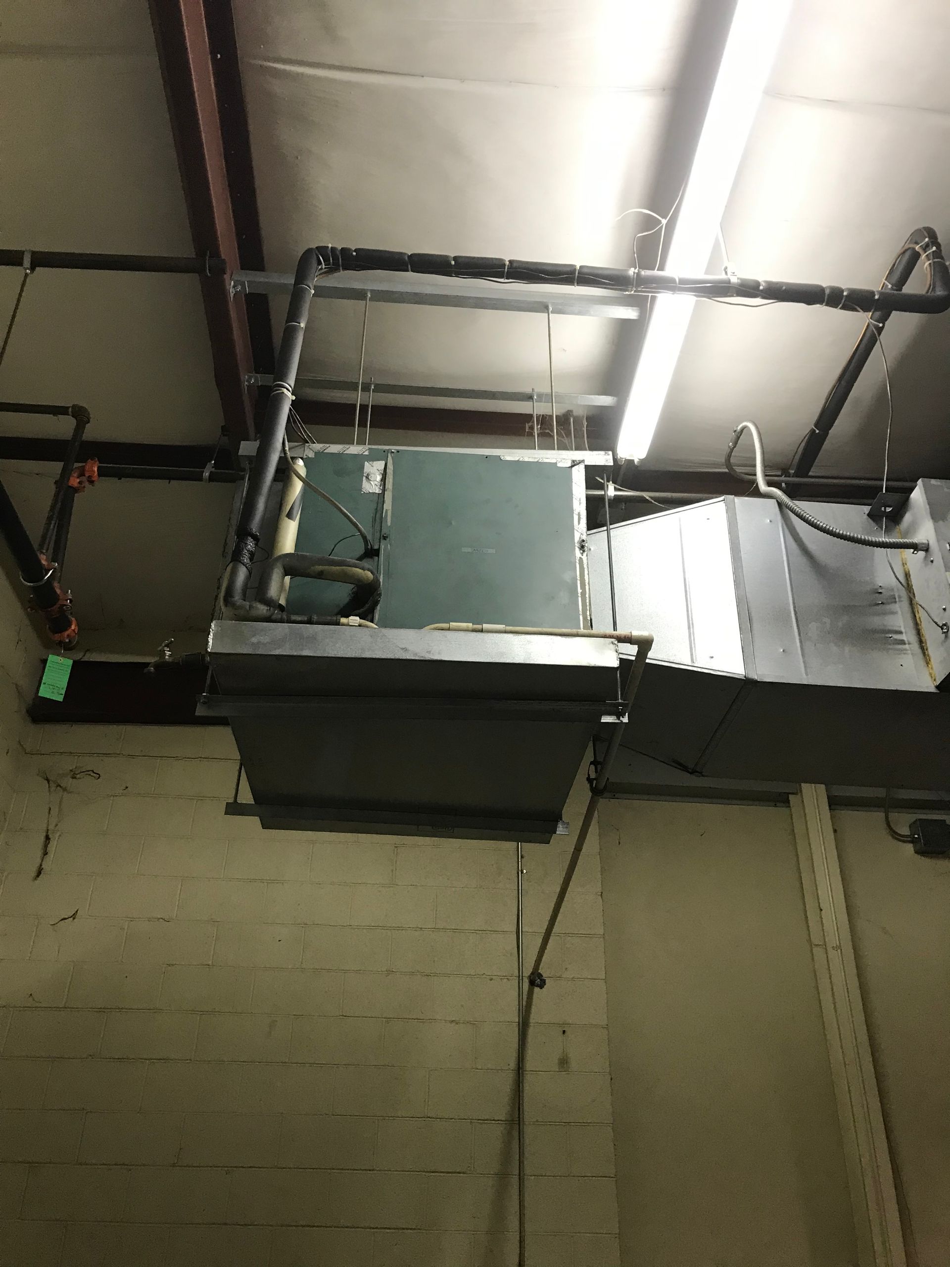 A ventilation system is hanging from the ceiling of a building