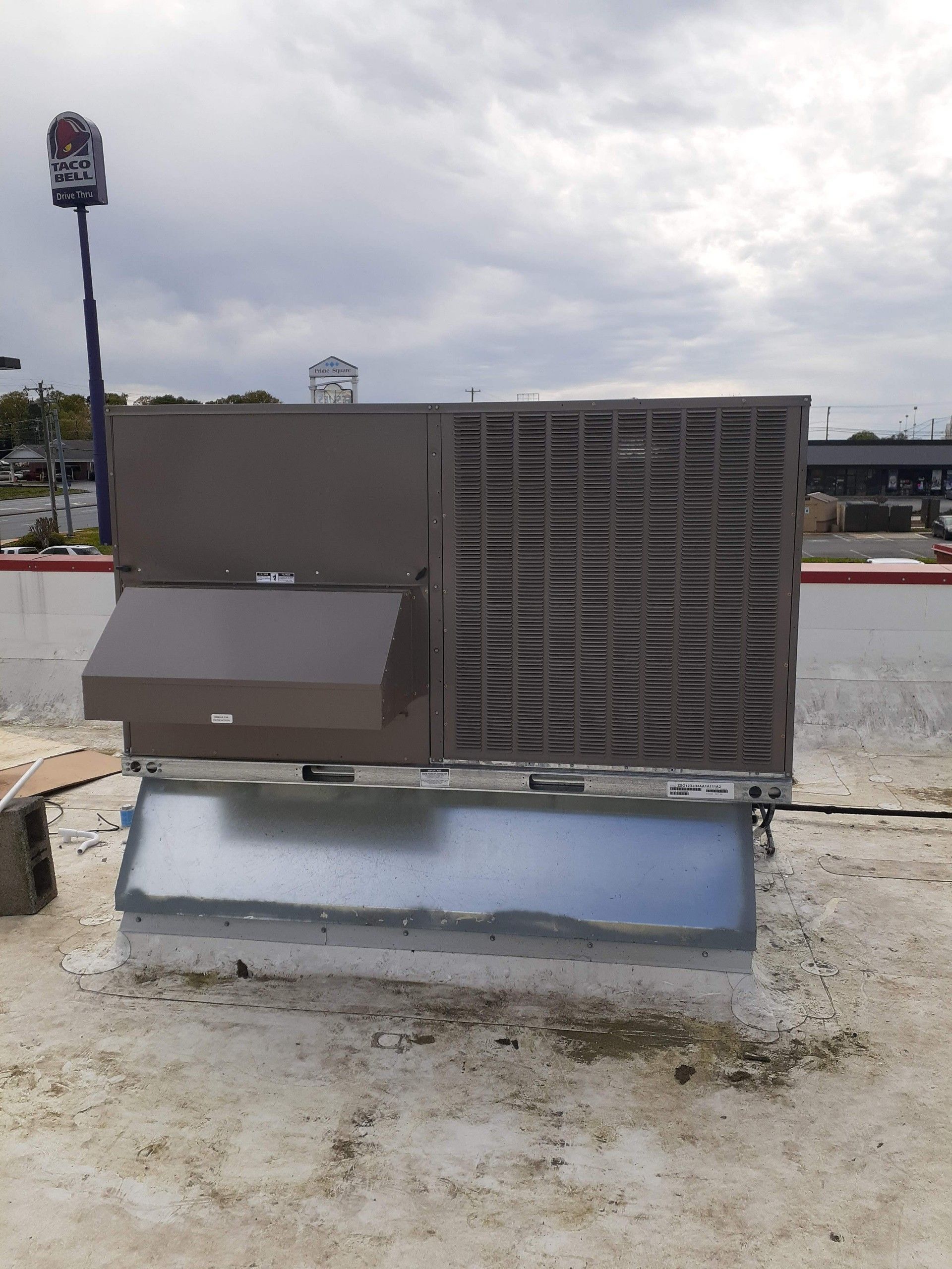 An air conditioner is sitting on the roof of a building