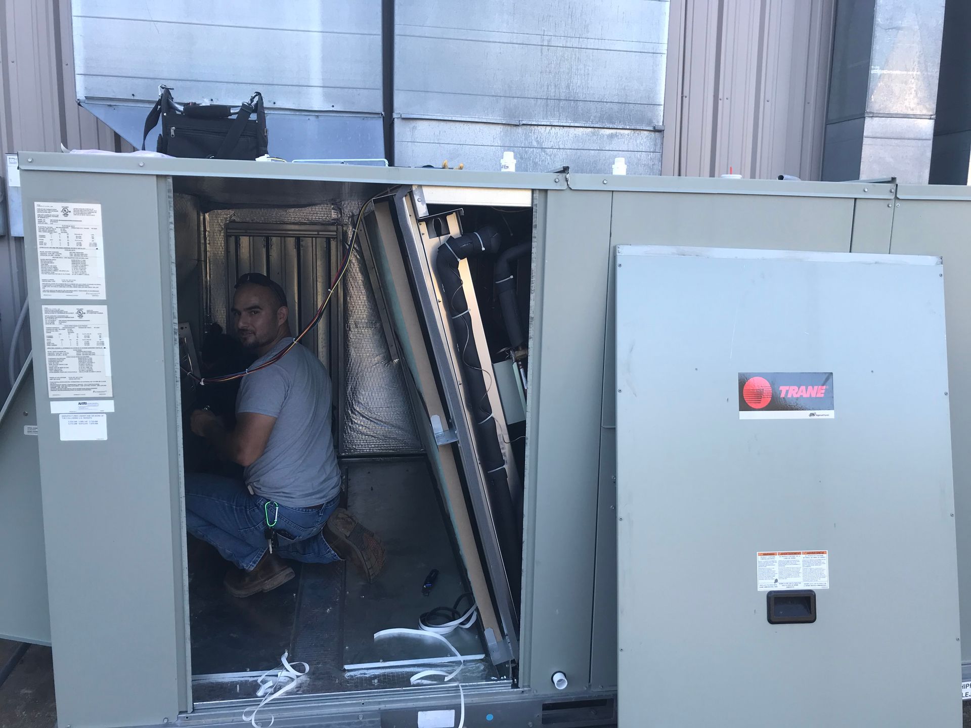 A man is sitting inside of a large box.