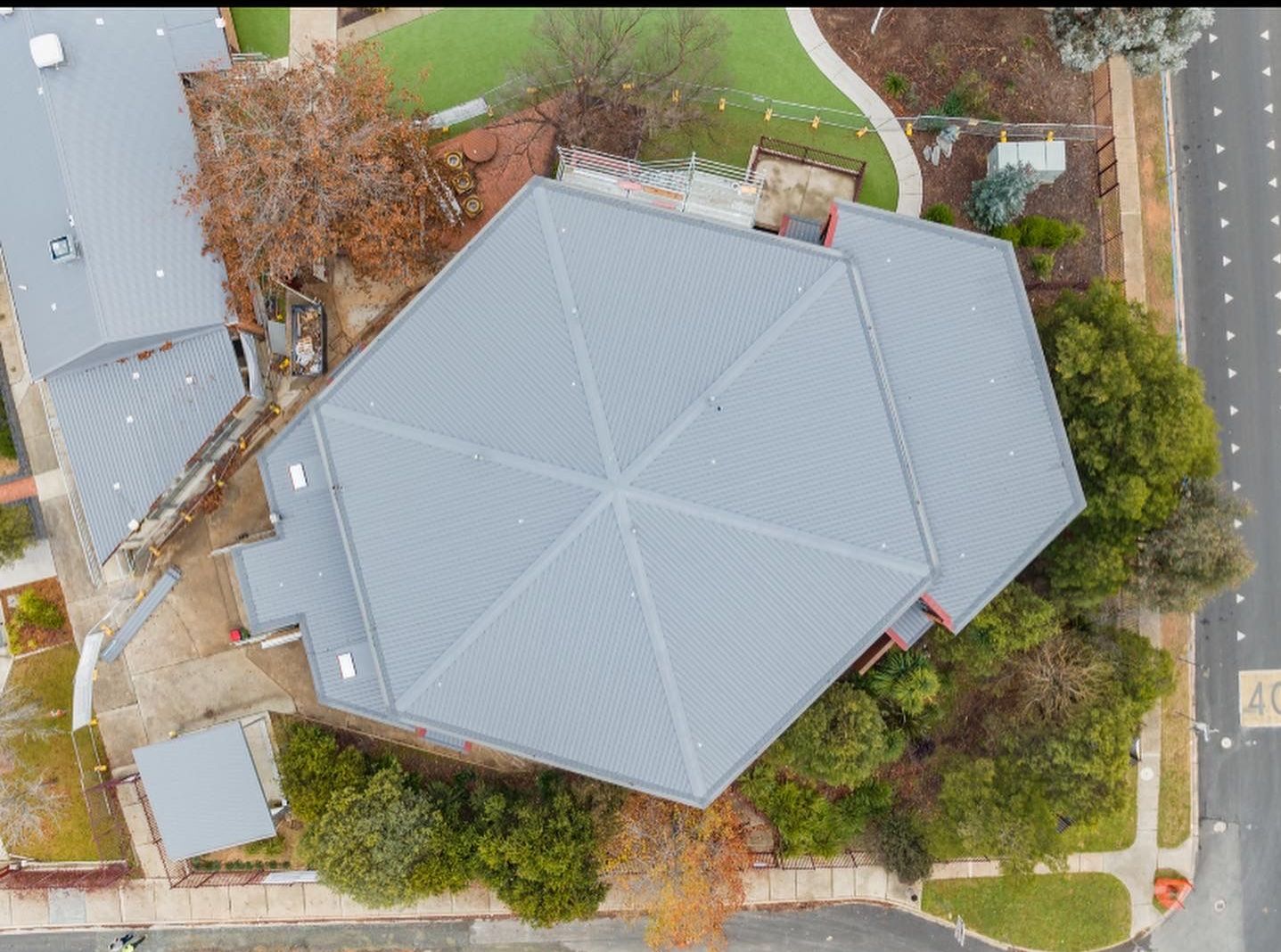 An Aerial View of a commercial building with grey roof— Lake Valley Roofing in Cardiff, NSW