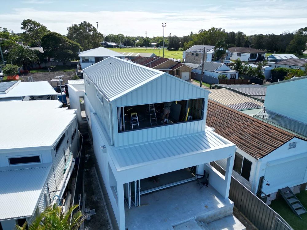 An Aerial View of a House Under Construction in a Residential Area — Lake Valley Roofing in Chisholm, NSW