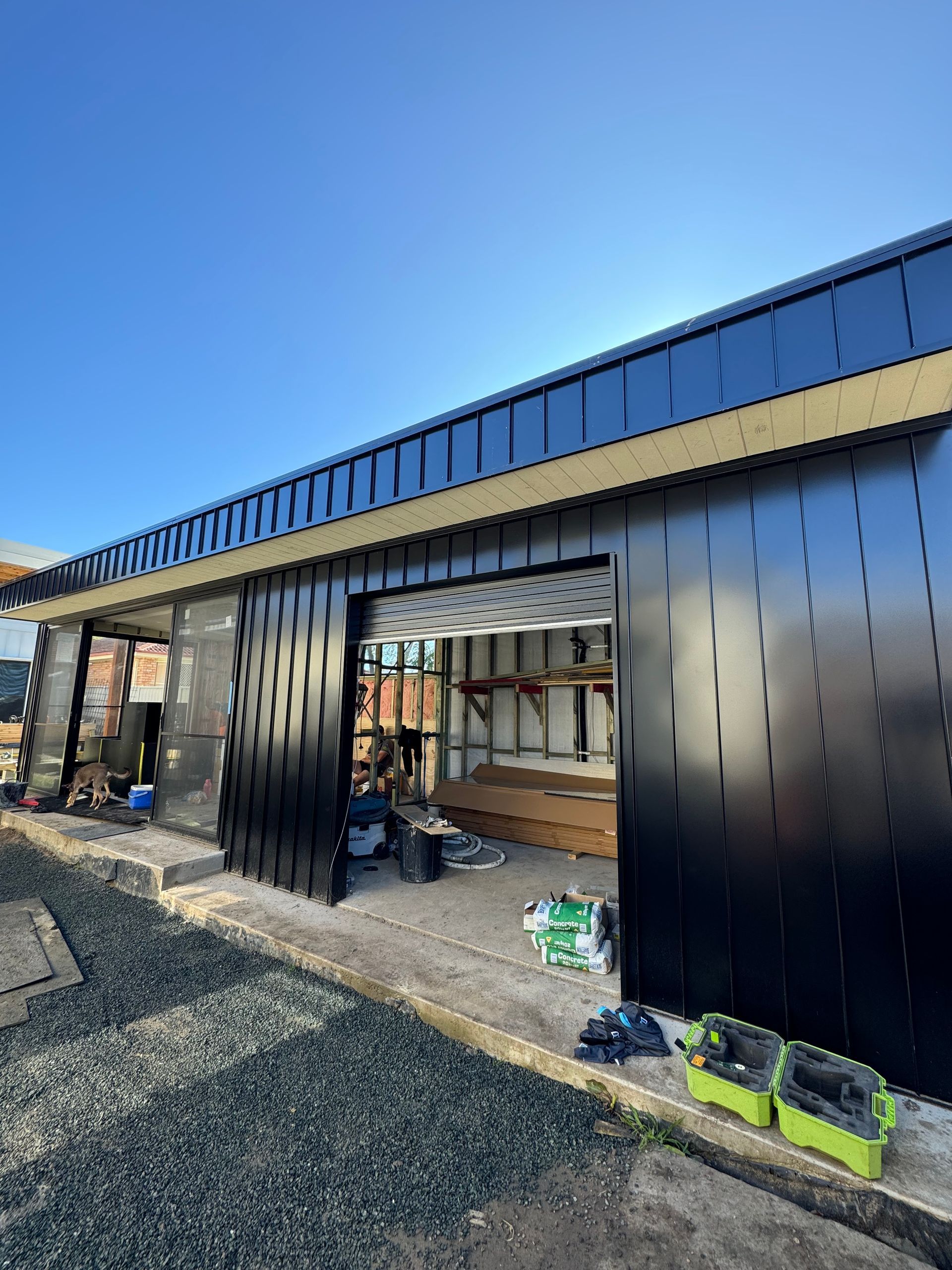 BLack cladding with openings and sliding doors — Lake Valley Roofing in Cardiff, NSW