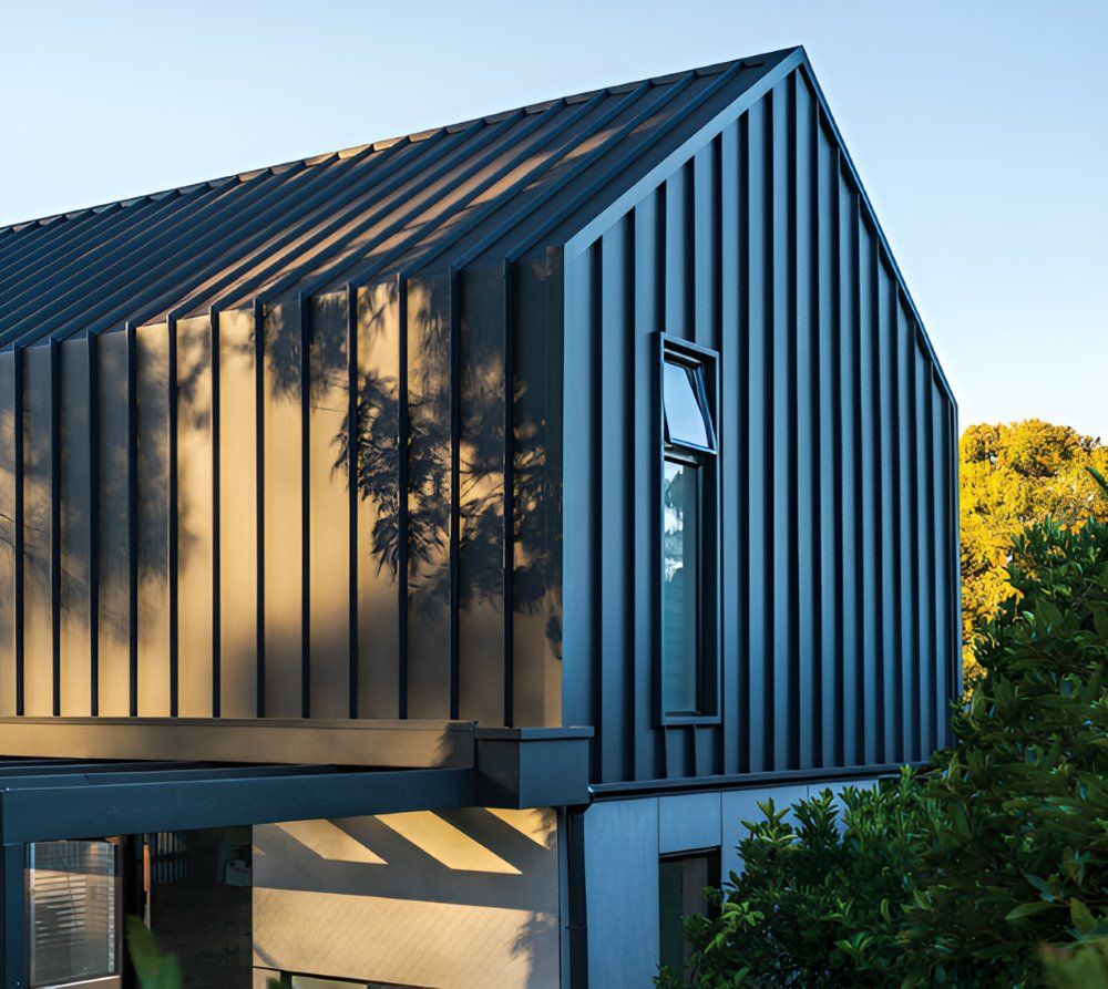 A Black House With a Roof That Looks Like a Barn — Lake Valley Roofing in Cardiff, NSW
