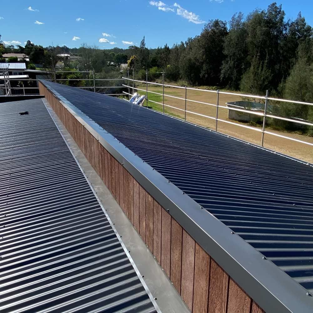 A Roof With a Wooden Railing and a Metal Roof — Lake Valley Roofing in Thornton, NSW