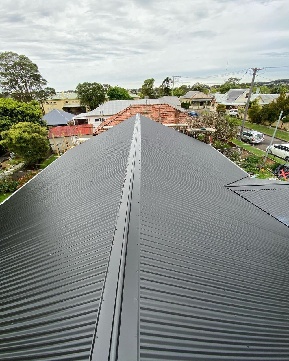 The Roof of a House is Covered in a Black Roofing Material — Lake Valley Roofing in Branxton, NSW