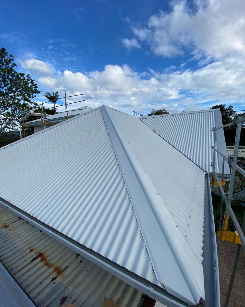 A White Roof With a Blue Sky in the Background — Lake Valley Roofing in Chisholm, NSW
