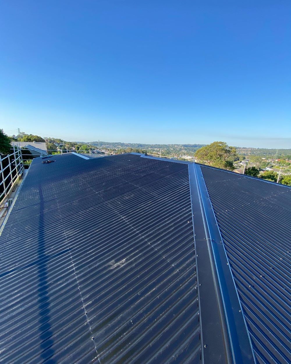 A Close Up of a Roof With a Blue Sky in the Background — Lake Valley Roofing in Fennell Bay, NSW