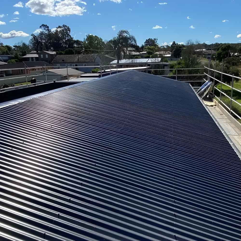 A Black Roof With a Blue Sky in the Background — Lake Valley Roofing in Fletcher, NSW