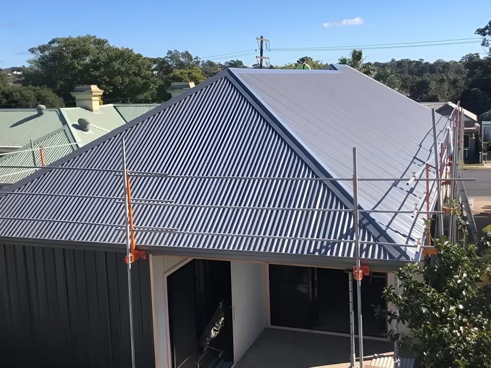 An Aerial View of a House With a Corrugated Metal Roof — Lake Valley Roofing in Fletcher, NSW