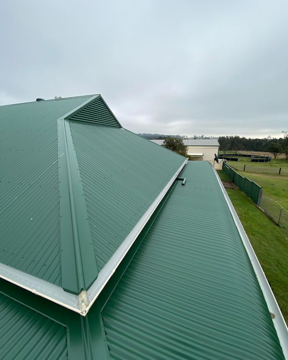 A Green Roof of a House With a View of a Body of Water — Lake Valley Roofing in Hamilton, NSW