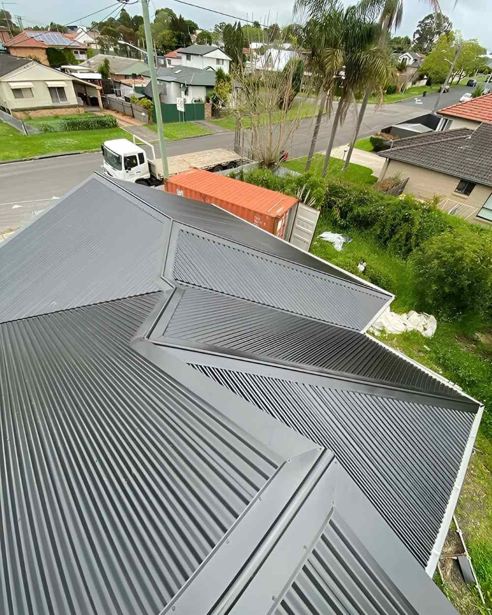 An Aerial View of a House With a Corrugated Metal Roof — Lake Valley Roofing in Mayfield, NSW