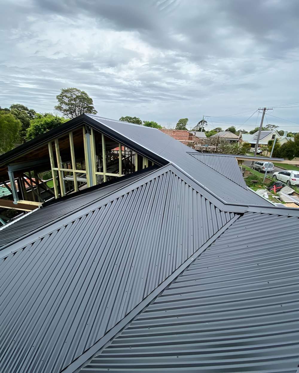 An Aerial View of a House Under Construction With a Corrugated Metal Roof — Lake Valley Roofing in New Lambton, NSW