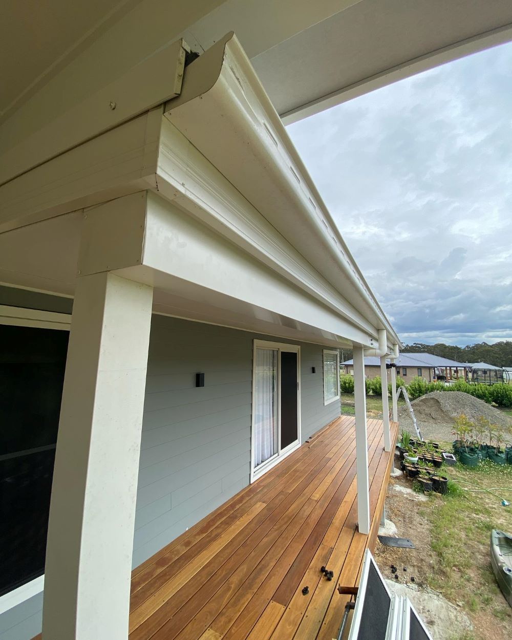 A House With a Wooden Deck and a White Gutter — Lake Valley Roofing in Valentine, NSW
