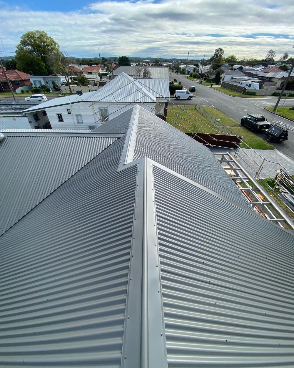 An Aerial View of a Roof With a Street in the Background — Lake Valley Roofing in Wallsend, NSW