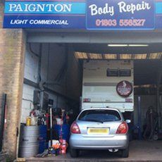 a garage shop that is hosting a car servicing work