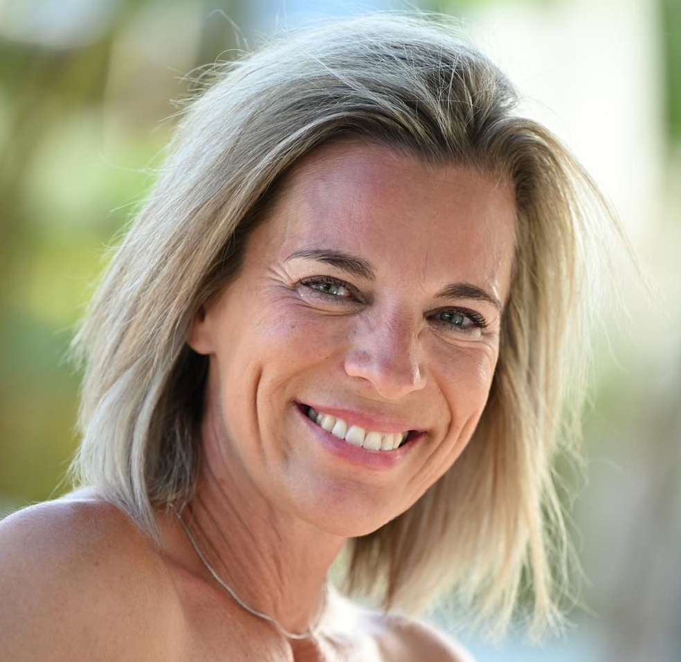 Shadow of a window frame on a light-colored wall; bright, rectangular light.