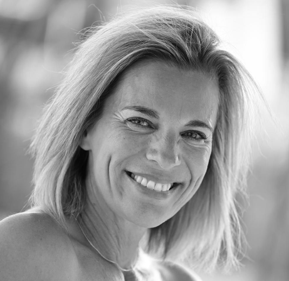 Bright light shining on a white wall creating shadows and a long rectangle.