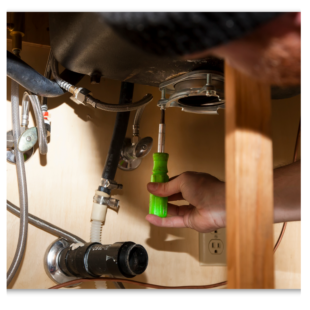 plumber repairing garbage disposal