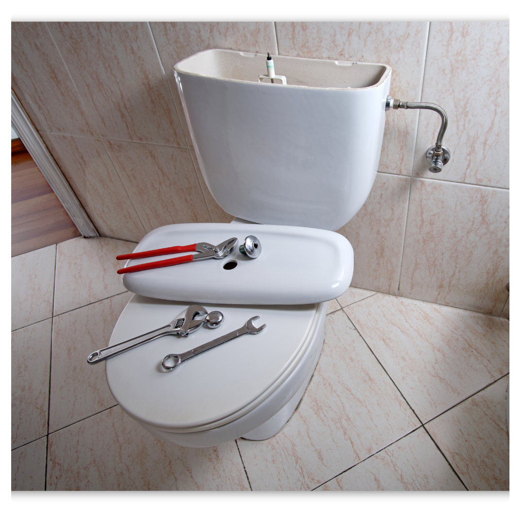 toilet with repair tools on top