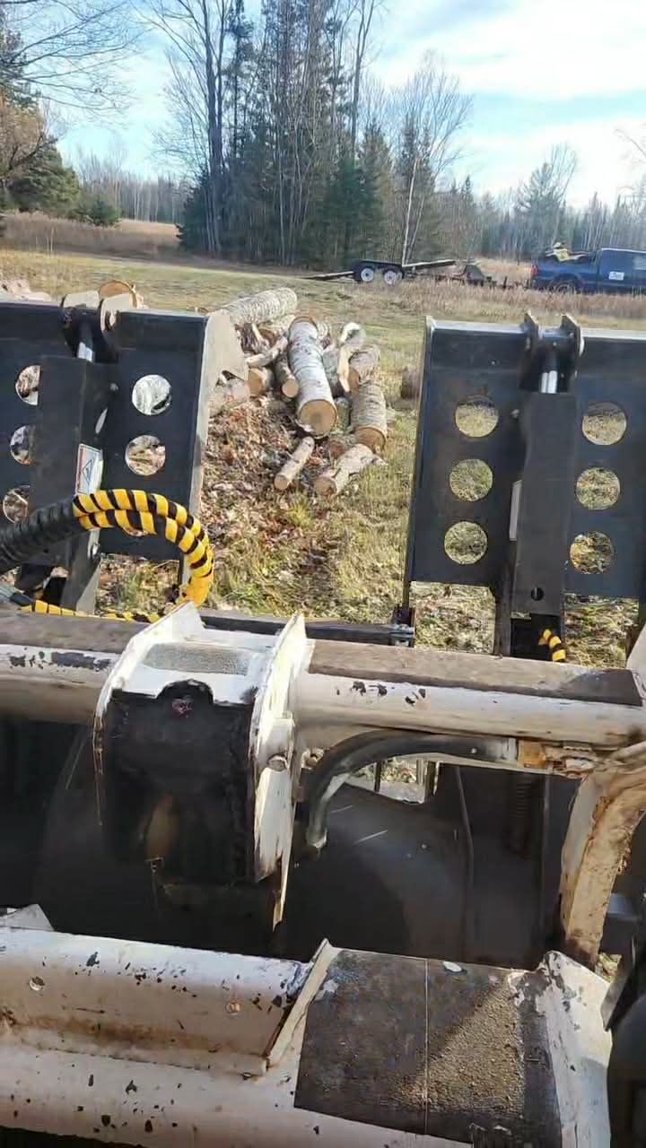 Person using a chainsaw to cut a tree branch.