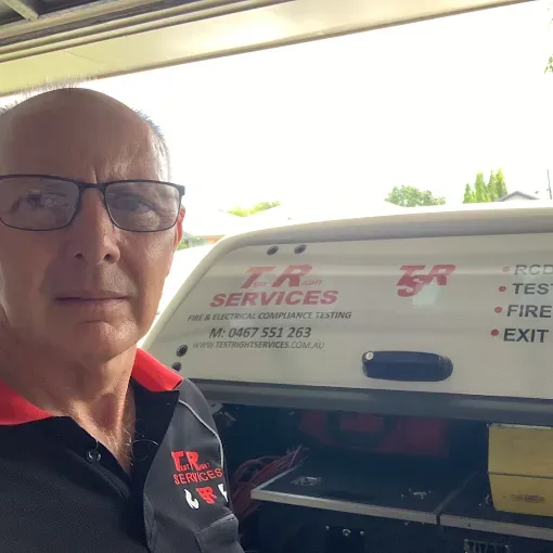 A Man Is Using a Multimeter to Test an Electrical Device — Test Right Services in Kirwan, QLD