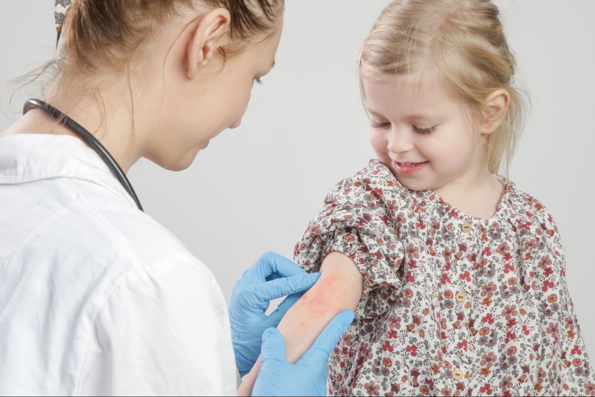 A Doctor Examines The Arm Of A Young Girl - New Bern, NC - ECDSS