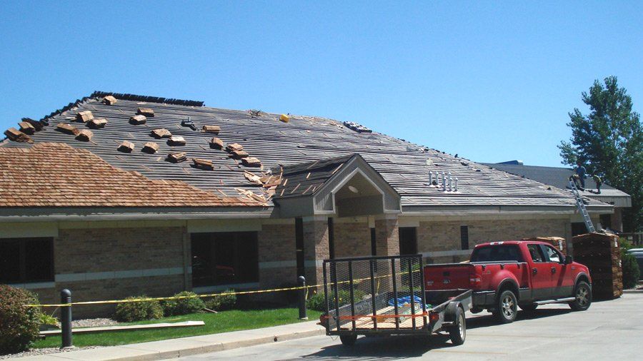 Damaged Roof Repair — Commercial Property Under Restoration in Mission, KS
