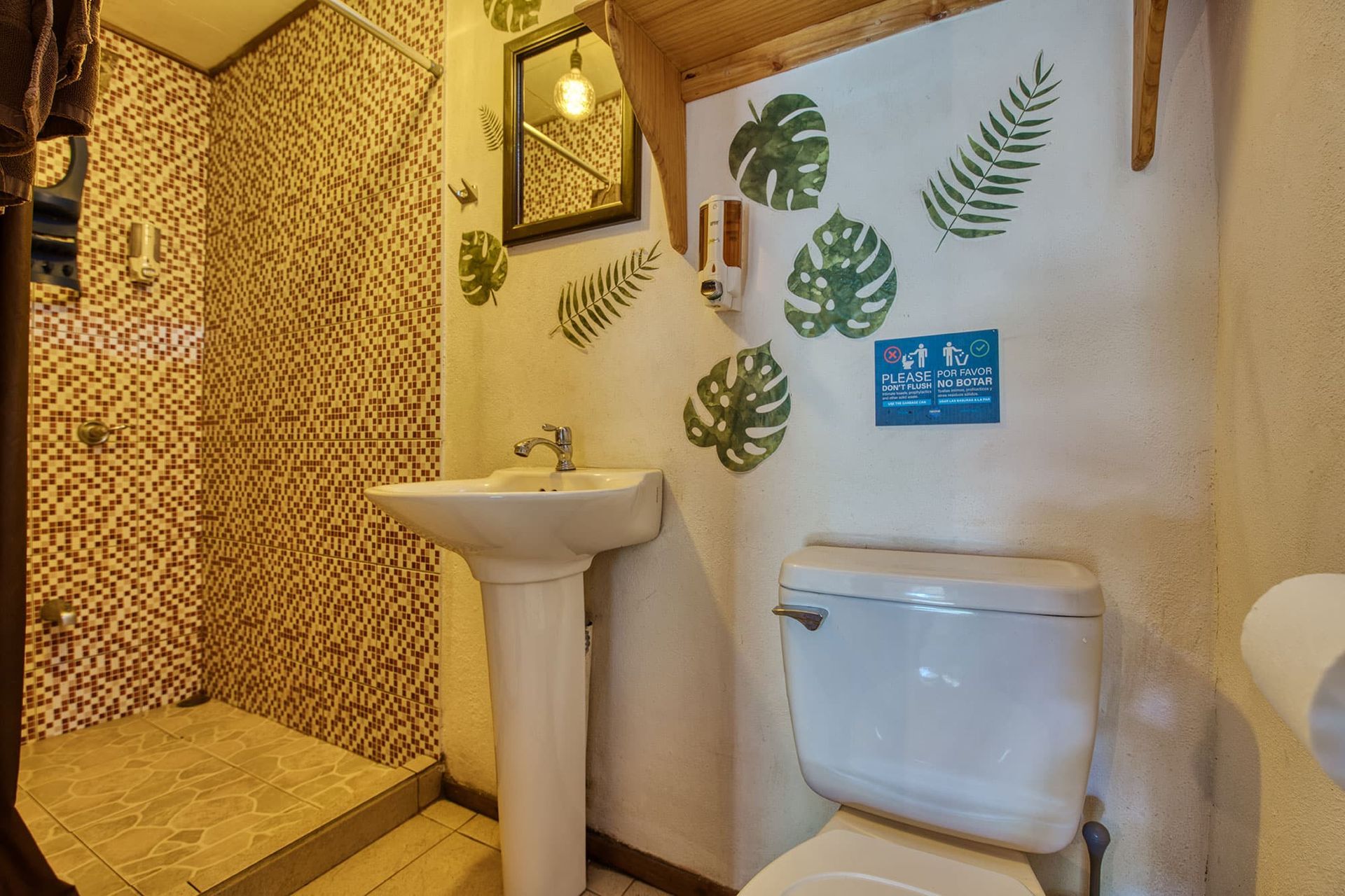 A bathroom with a sink , toilet and shower.