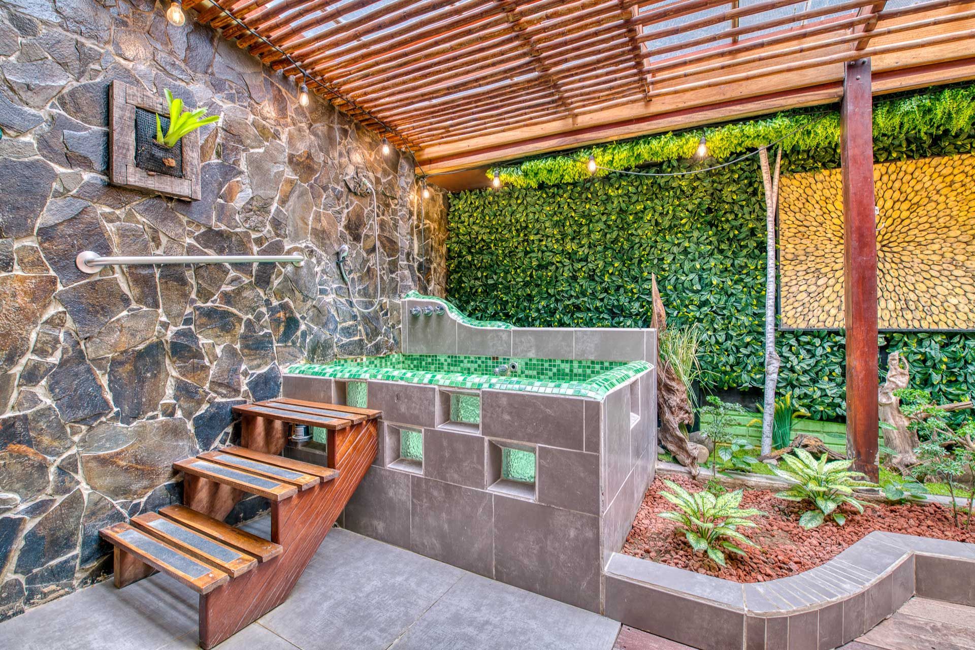 There is a hot tub in the backyard with stairs leading up to it.