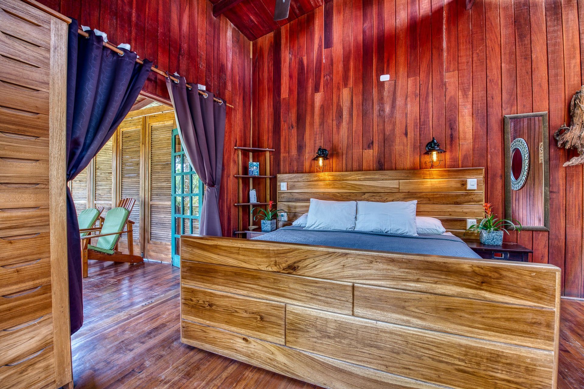 A bedroom with wooden walls and a wooden bed.
