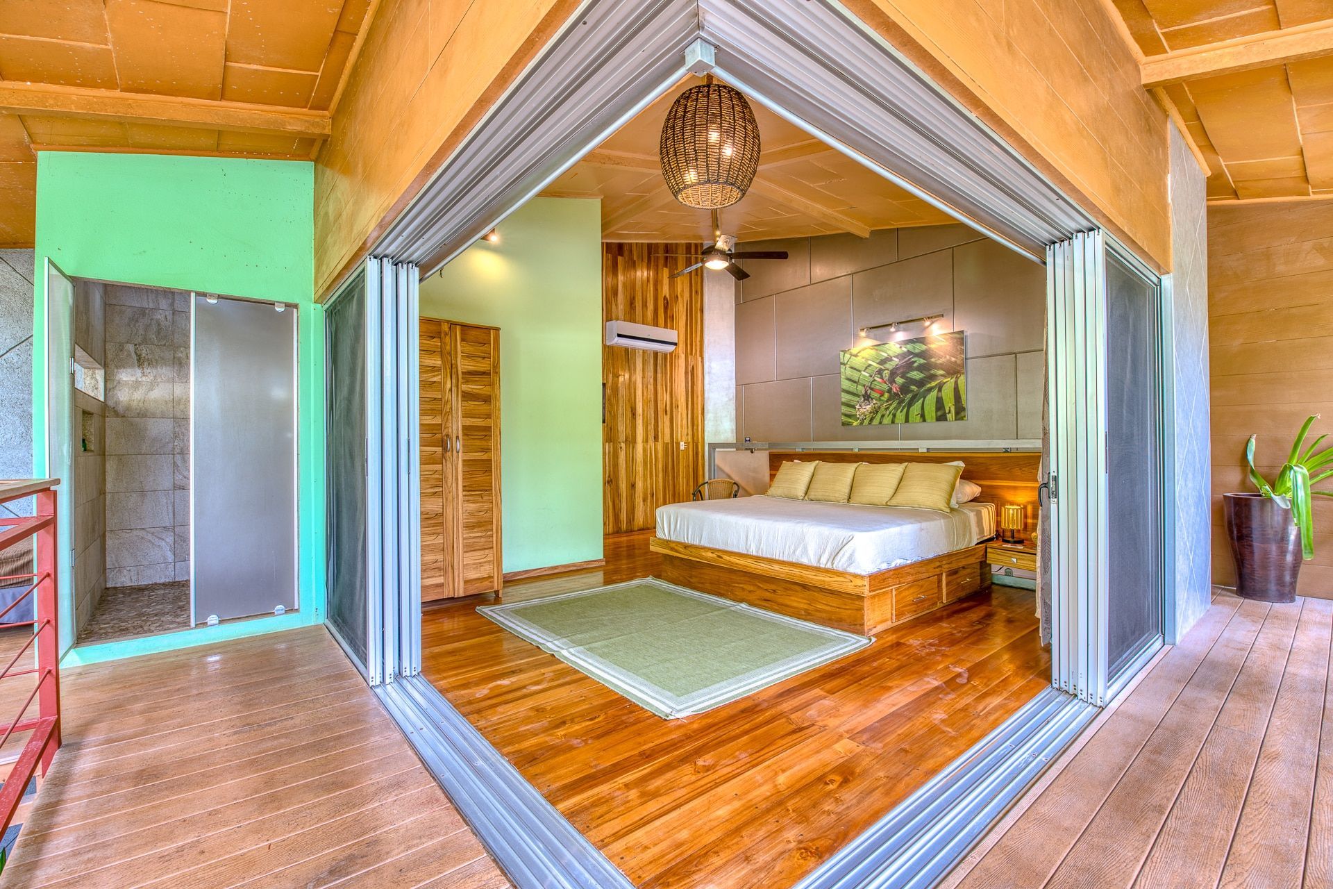 A bedroom with a king size bed and sliding glass doors.