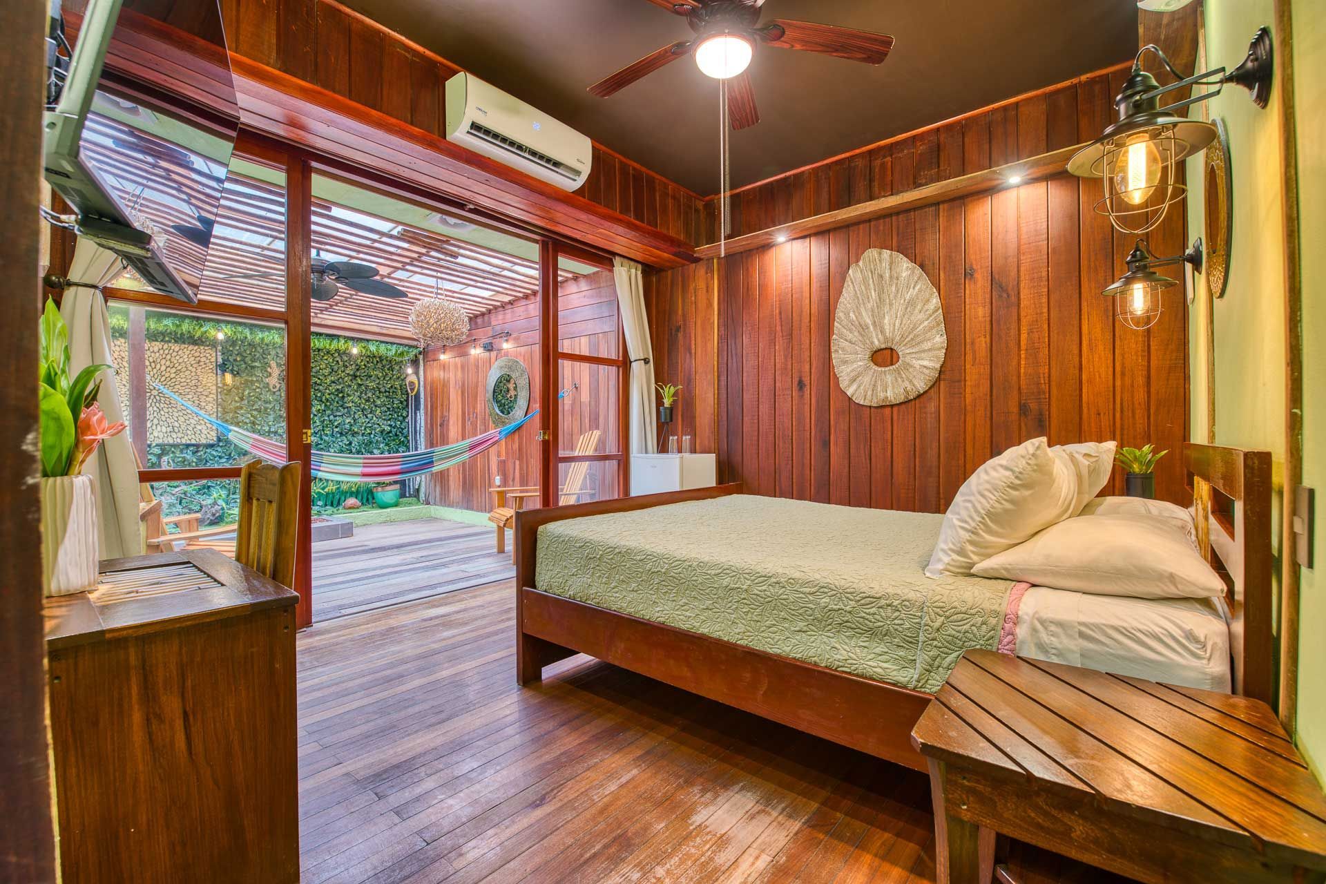 A bedroom with a bed and a ceiling fan.
