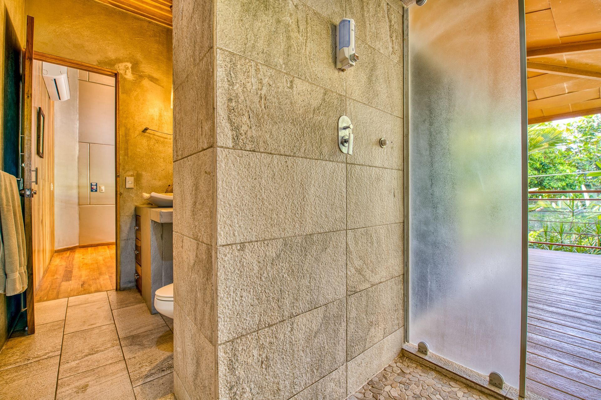 A bathroom with a walk in shower and a toilet.